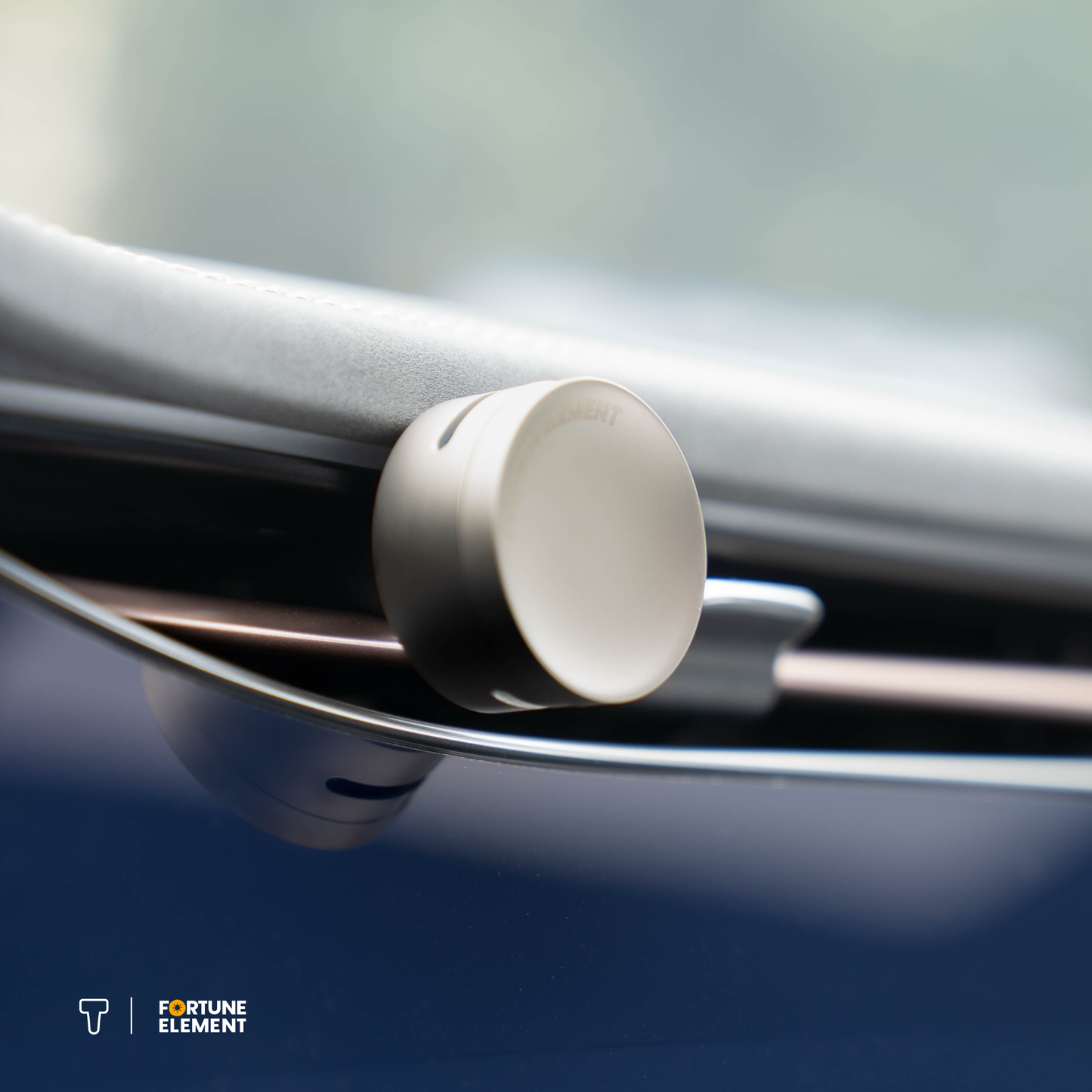 A close-up shot of the fortune element car diffuser clipped into the car's vent, highlighting its secure attachment and integration with the vent design