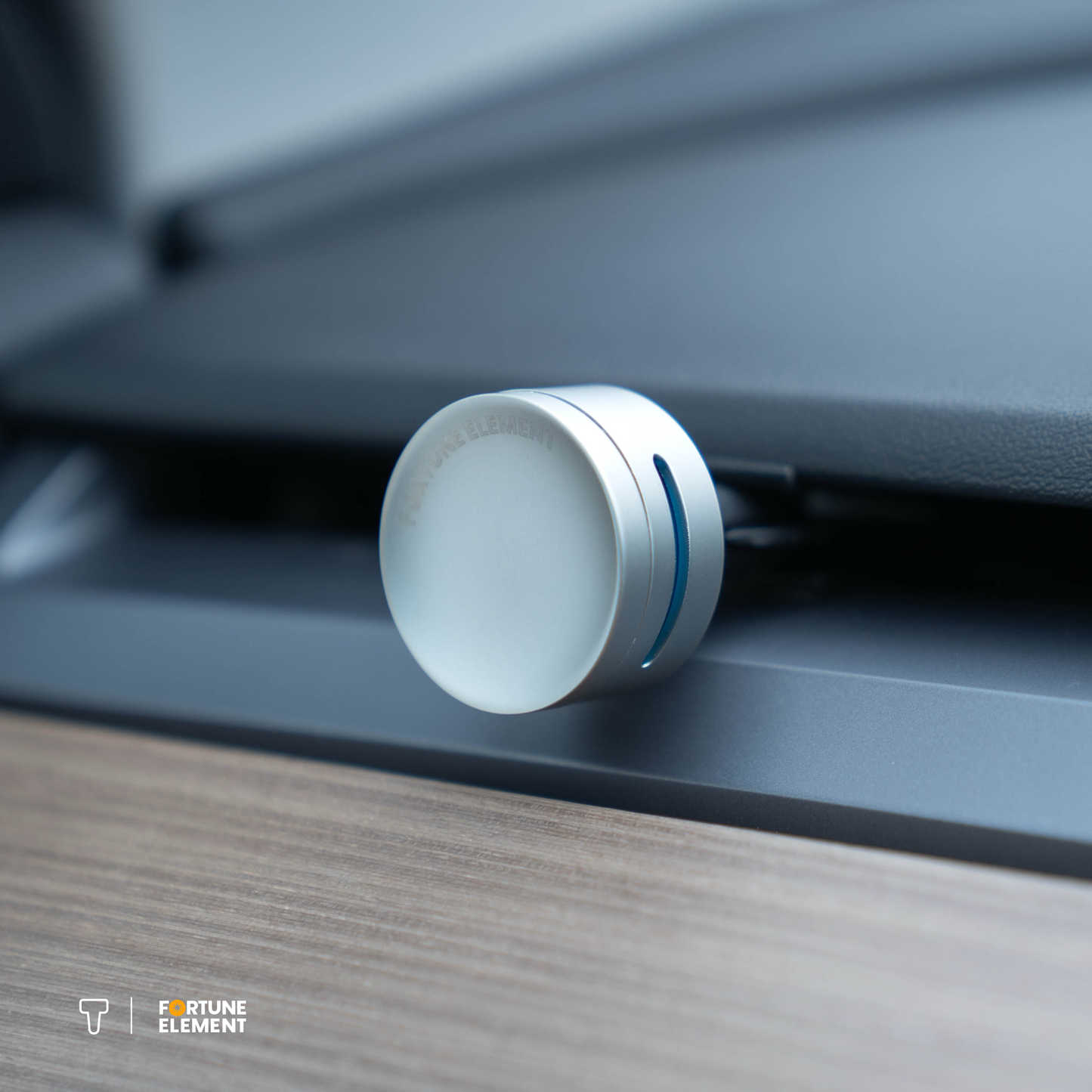 A close-up shot of the fortune element car diffuser clipped into the car's vent, highlighting its secure attachment and integration with the vent design